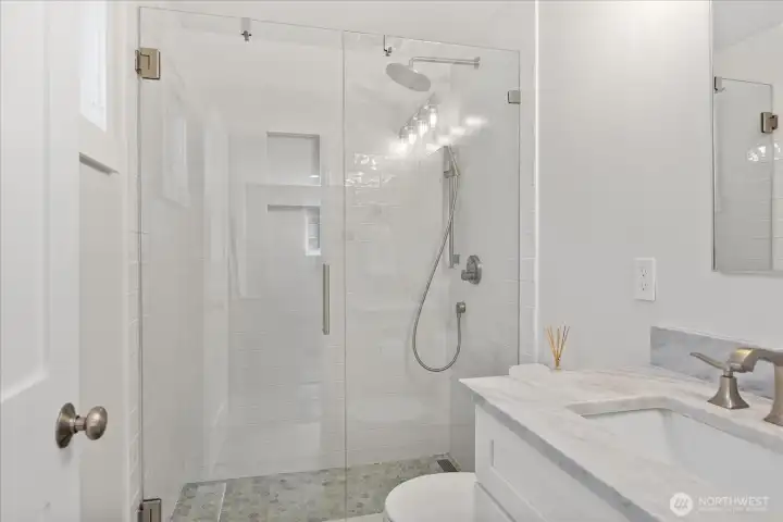 The recently updated primary bathroom features a walk-in shower.