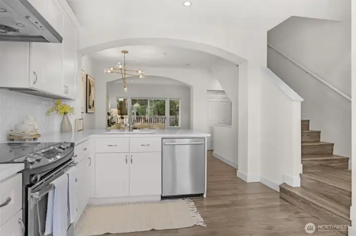 Updated kitchen with quartz countertops and stainless steel appliances.