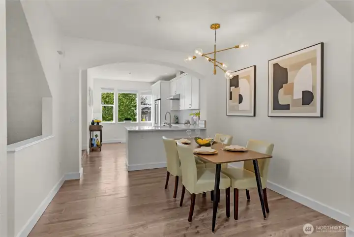 Bright dining area accented by a stylish modern chandelier.