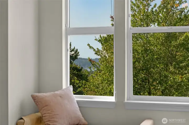Enjoy stunning lake and city views from the comfort of the primary bedroom.