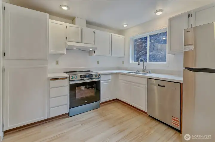 Updated kitchen with lots of light opening to a dining area with sliding doors and new deck.