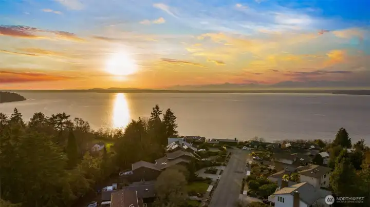 Enjoy beautiful sunsets over the water from you front and back decks! The living room, dining room, family room, primary bedroom, and the second top floor bedroom all have lovely views.