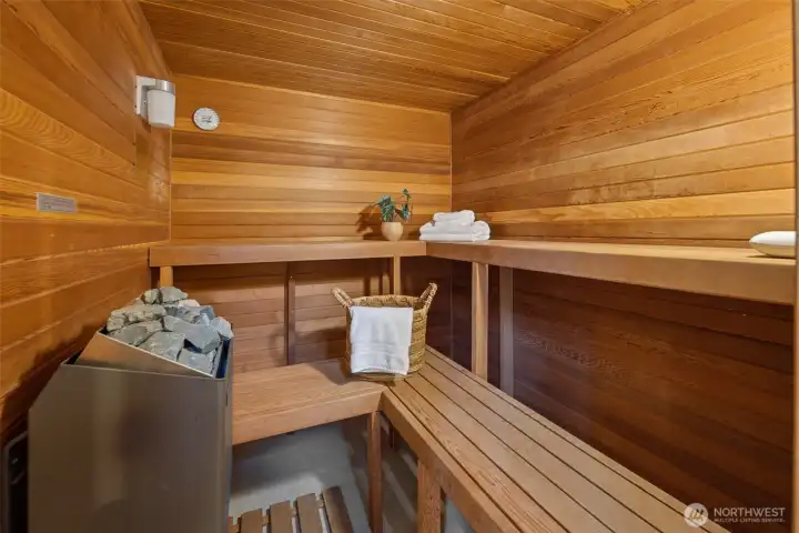 The pool room also features this wonderful sauna, as well as a steam shower, a three quarter bathroom, and a small kitchen with a stove, sink and fridge!