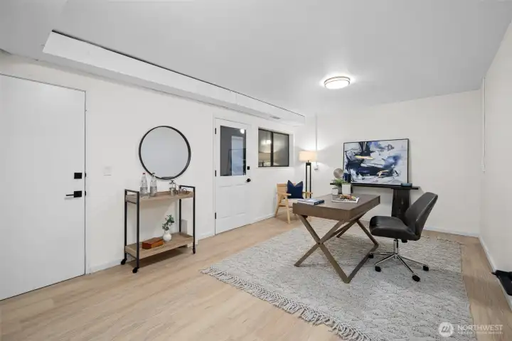 This lower level bedroom is accessed from the rec room and lower bathroom, or from this door that leads to the covered patio area and garage. The floor is brand new, with fresh paint and new ceiling light. This room would make a great home office too.