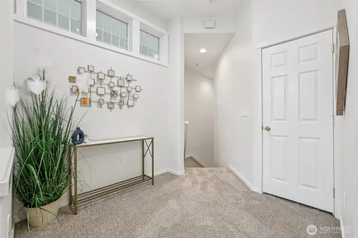 Main floor landing looking back to stairs, coat closet on right.