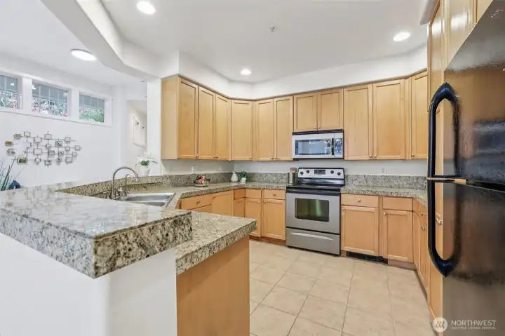 Exceptional kitchen layout with tile floors, granite countertops and loads of cabinetry!