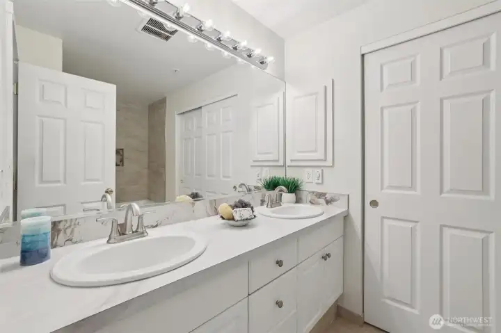 Dual sink vanity with door to walk in closet