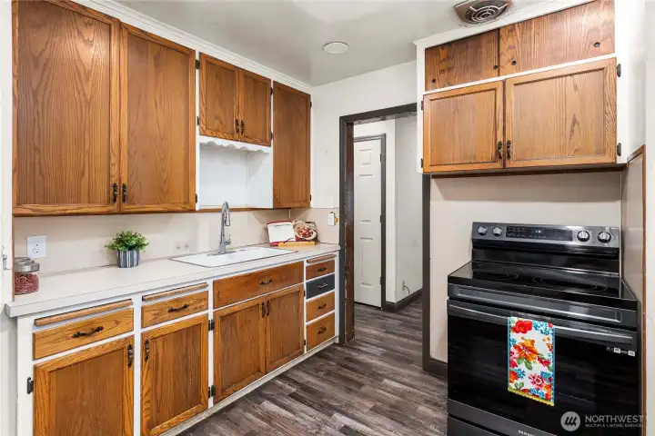Efficient kitchen offers newer range and stainless fridge (located to the left of this photo).