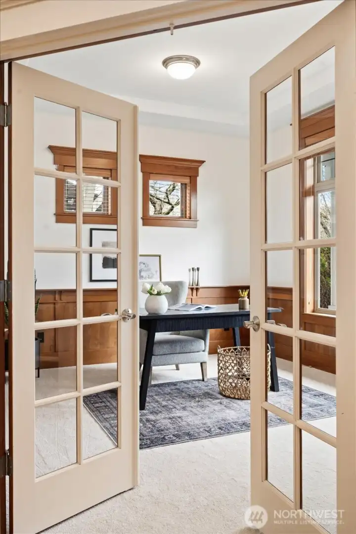 Just off the entry and through the beautiful French doors is the thoughtfully designed office with architectural details.