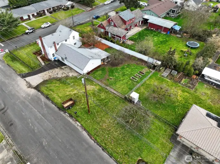 You can see there's alot more yard in the back here and to the side as well. 3 raised garden beds and 2 fruit trees. A cherry & a 100 year old apple tree that produces delicious red apples.