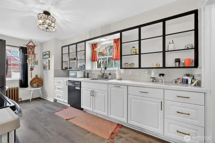 Gererously sized kitchen with quartz countertops, walk in pantry, double ovens, plenty of cupboard space & laminate floors.