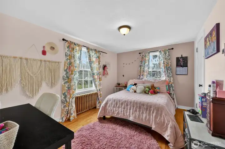 Bedroom 2 with hardwood flooring.