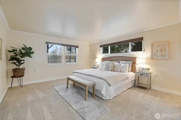 This is the downstairs primary bedroom with its own full bath and large walk in closet. Peek a boo water views too!