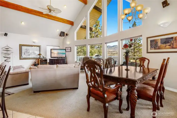 Bright living area with expansive windows showcasing the surrounding landscape and water views.