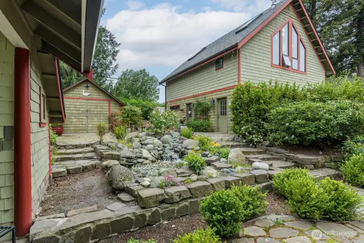 Serene water feature with small shop between the garage and house...