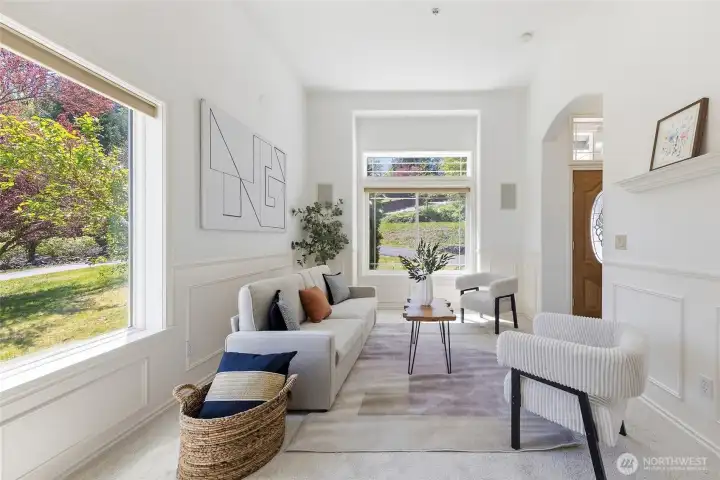 Formal living room with large windows.