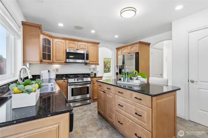 Kitchen with granite counters and stainless steel appliances.