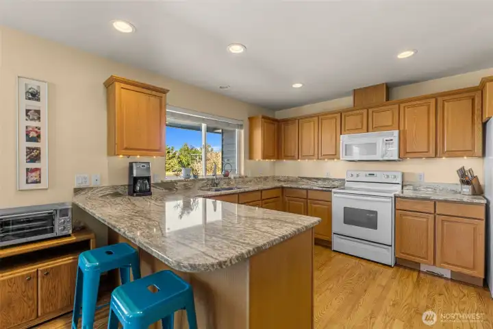 Beautiful natural hardwood flooring, updated stylish quartz counters and up to date appliances.