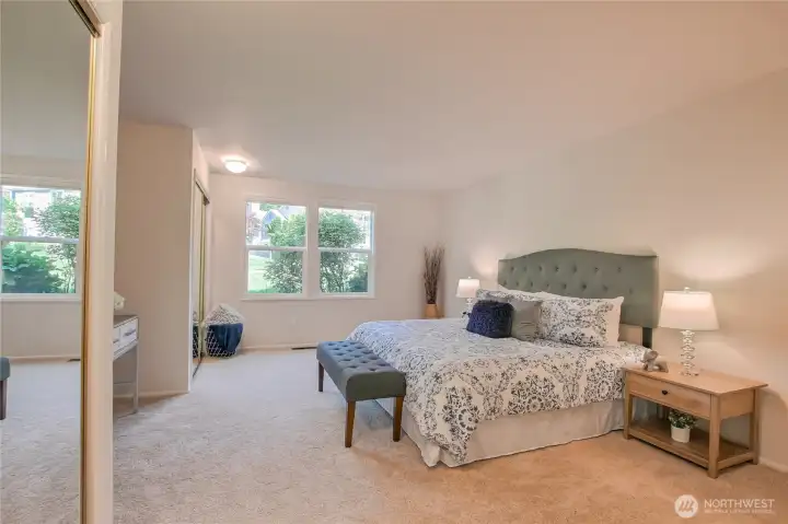 Primary bedroom suite with dual closets and private grass views.