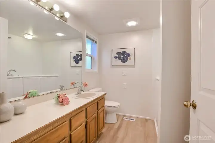 Primary full bath has new LVP flooring and Kohler bath/shower.