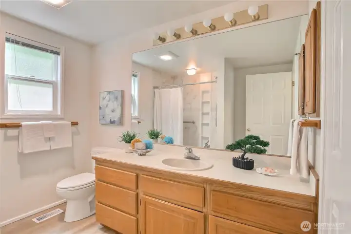 Hall bath with step in shower.