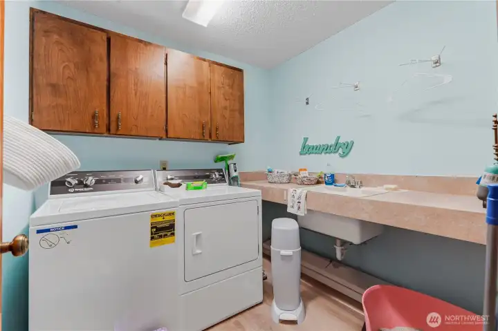Large laundry room with folding counter and sink.