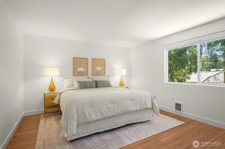 Spacious primary suite w/new double pane vinyl window overlooking backyard.