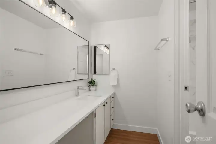 Hall full bath also has private vanity outside shower.