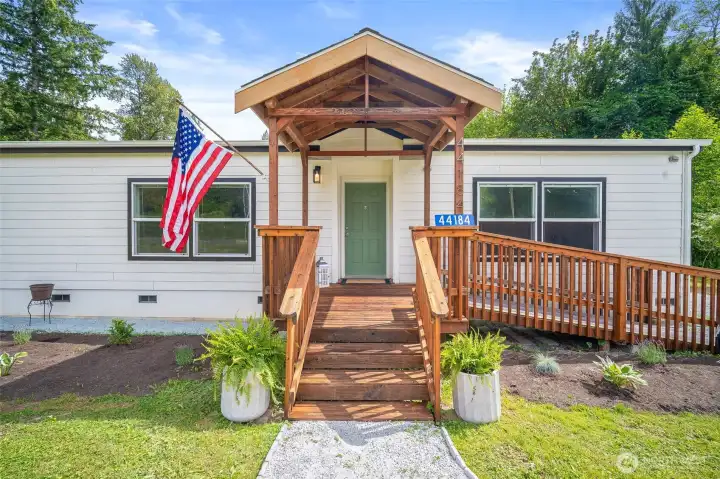 The charming covered entry with wheelchair ramp accessibility.