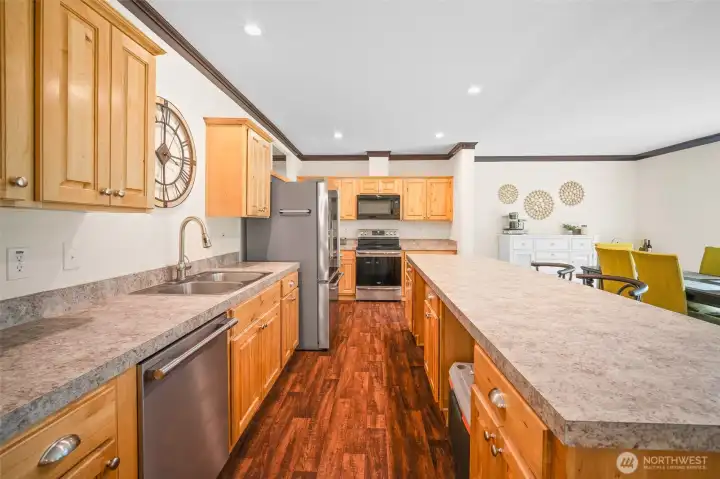 Warm wood cabinetry, plenty of counter space, and a kitchen that is ready to entertain.