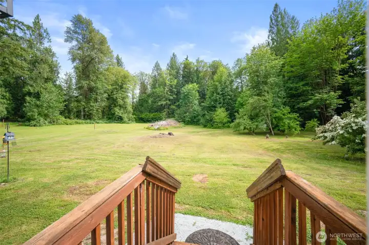 Off the back slider a view of the open lawn and mature trees.