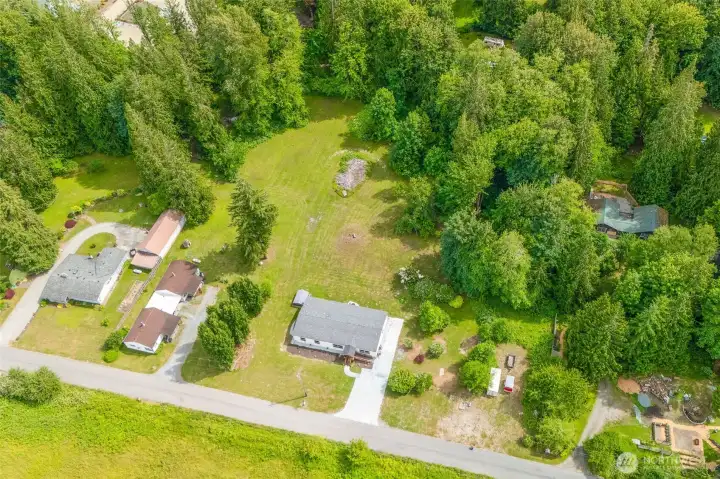Aerial shot showing the full footprint of the property, home, and ample parking.