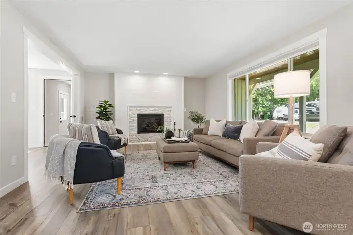 Nice spacious living room with large front window and cozy gas fireplace Nice spacious living room with large front window and cozy gas fireplace