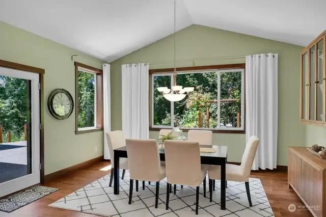 Dining room overlooking colorful back yard & patio.