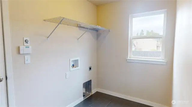 Laundry room is located downstairs with access to the 2-car garage