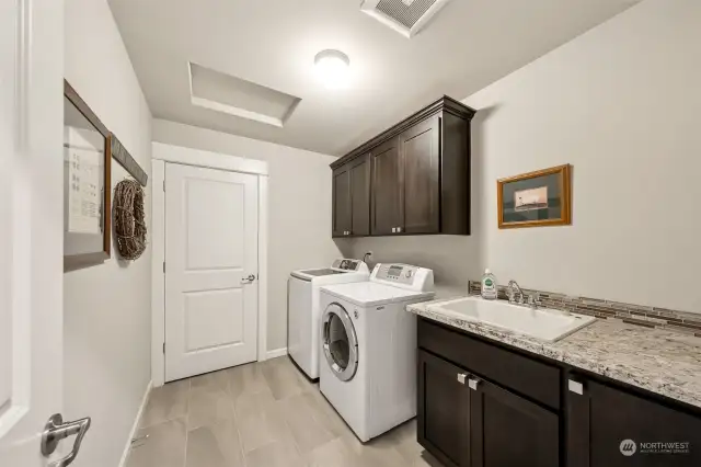 Upstairs laundry with sink and cabinets