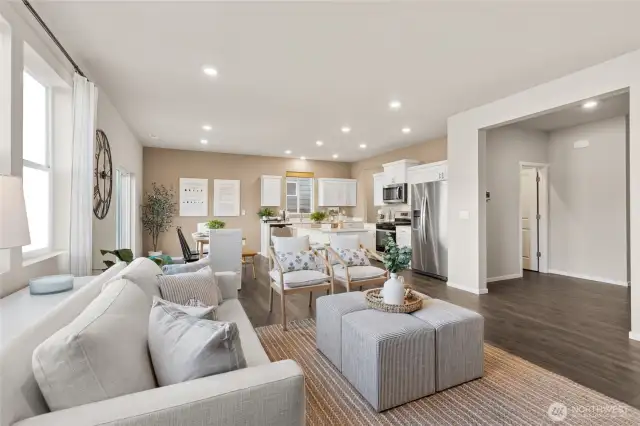 Living Room, Dining and Kitchen. Photos are of model home of the same plan and may reflect different colors and options.