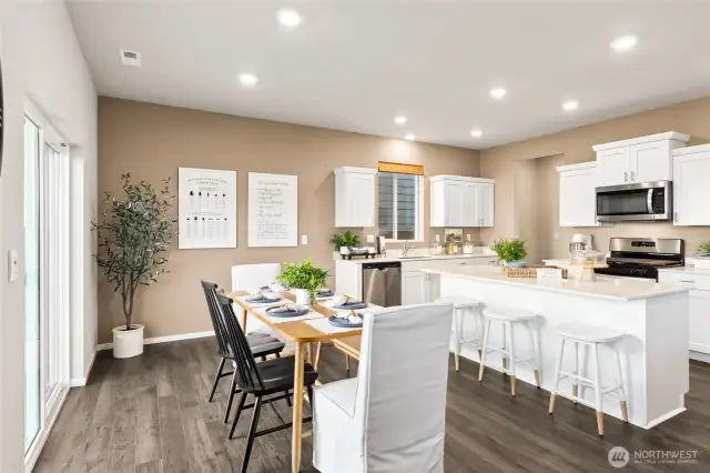 Dining and Kitchen. Photos are of model home of the same plan and may reflect different colors and options.