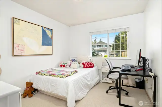 Large bright bedroom with space for dresser, desk and bed.