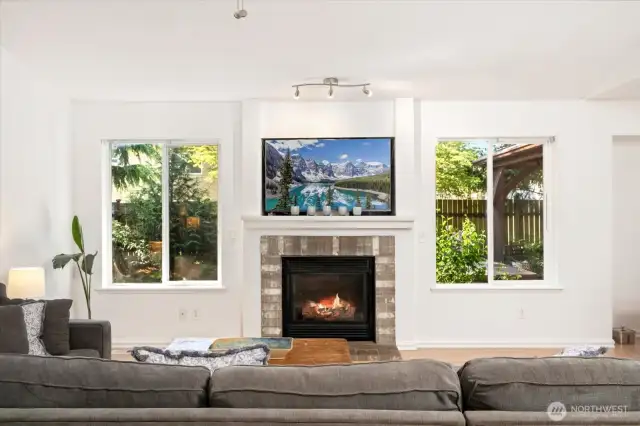 Large living room with vaulted ceilings and gas fireplace adjacent to the dining area and steps from your backyard deck and hot tub for total relaxation.