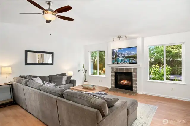 Vaulted ceilings in the main living area with stately brick surround gas fireplace.