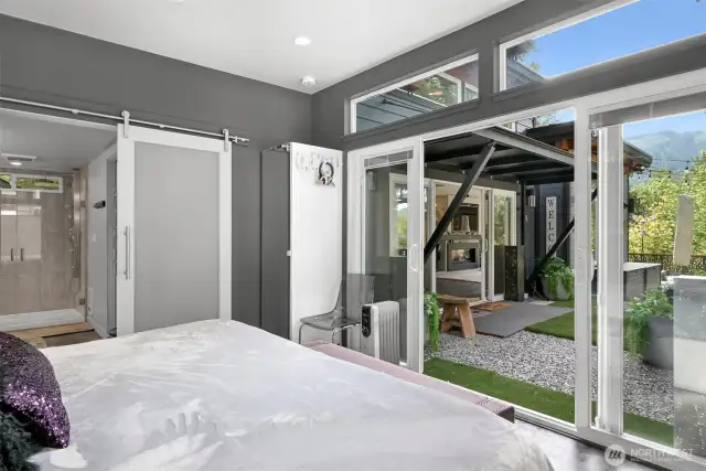 Primary bedroom w/ sliding doors to the outside.