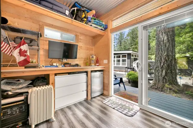 Inside the shed. Note the refrigerator and TV.