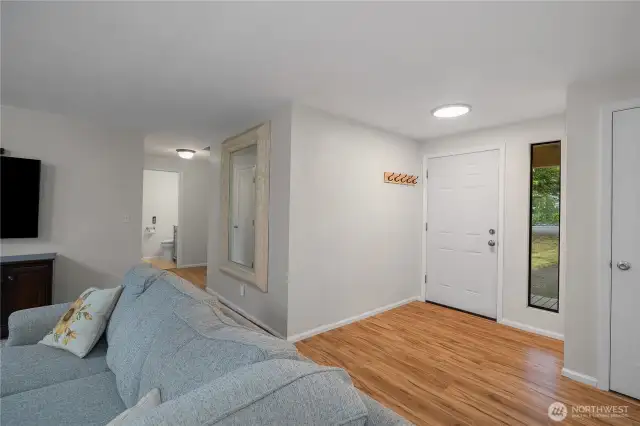 Living room looking towards front door, bathroom and bedrooms