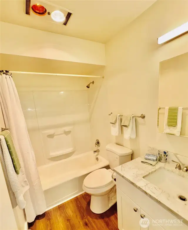 Gleaming bathroom. Chrome fixtures, toilet, sink, cabinet, lighting & mirror cabinet are new!