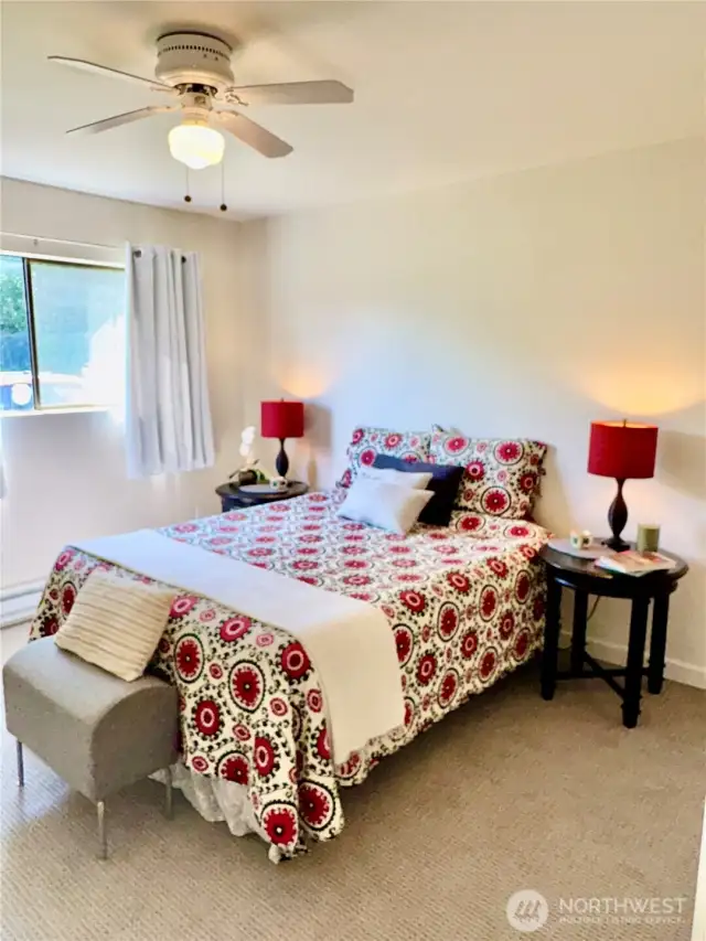 Nicely sized bedroom; easily holds this queen size bed; plenty of room to upsize to a king. Ceiling fan keeps things cool and cozy.
