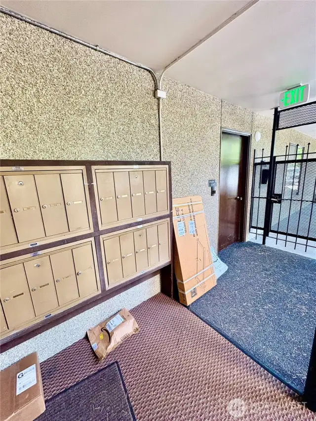 Secure mail and package delivery. The door at the right is a stairway thru to the  lower parking, or upper levels.
