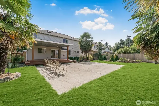Fully fenced Backyard with lush landscaping.