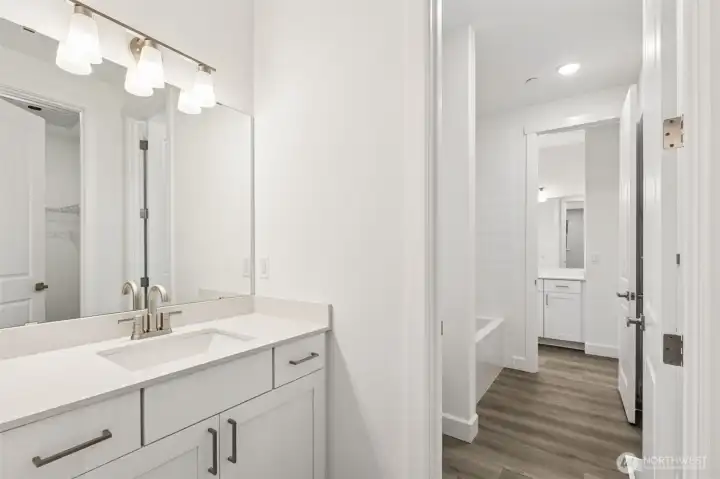 Jack and Jill Bathroom connects two of the upstairs bedrooms. Each has its own vanity and walk-in closet.