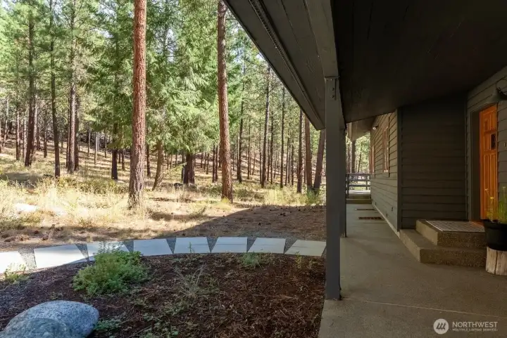 Walkway to front door and covered aggregate patio.